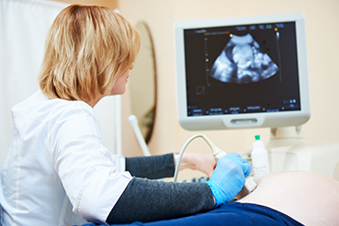 Doctor analyzing a fetal monitor