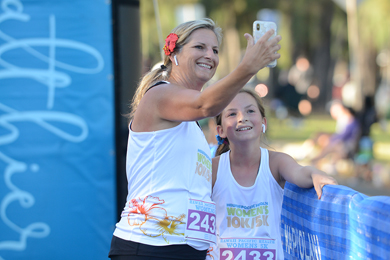 Mother and Daughter taking a selfie together at the finish line