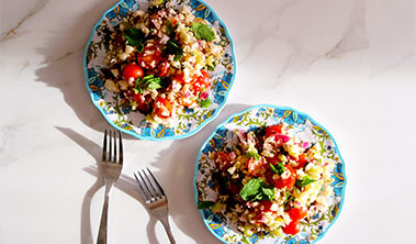 two small but heaping plates of tabbouleh salad