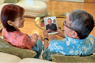 Couple at home speaking with doctor on tablet.
