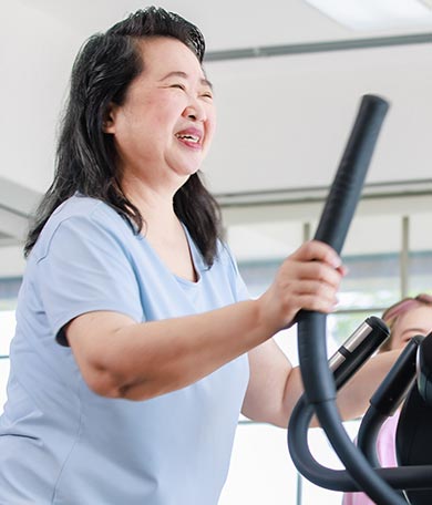 Smiling woman on treadmill.