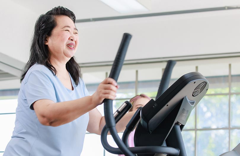 Smiling woman on a treadmill.