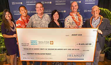 Group shot with giant check.