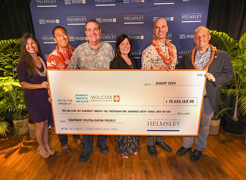 Group shot with giant check.