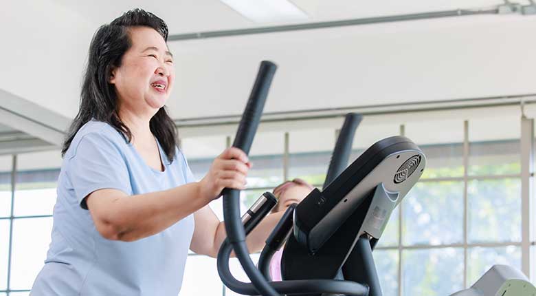 Smiling woman on treadmill.