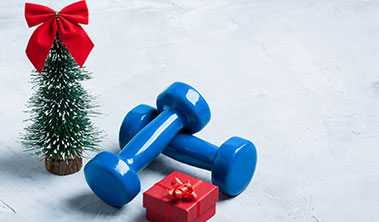 Small set of blue weights with Christmas tree and present.