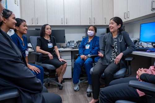 Dr. Liana Kobayashi (right) meets with staff and students at the Waipahu Academic Health Center.