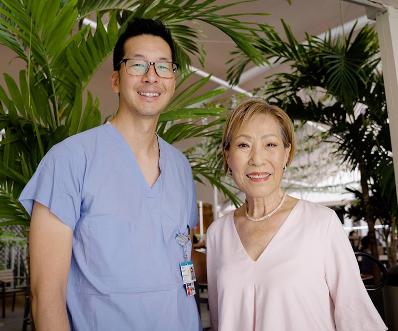 Dr. Jeremy Lum stands with Chung Lucky in the Rotunda at Straub Benioff Medical Center