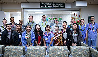 Group shot of large caregiving team wearing scrubs and lei at Straub Benioff Heart Center.