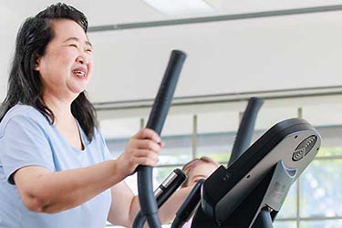 Smiling woman on treadmill.