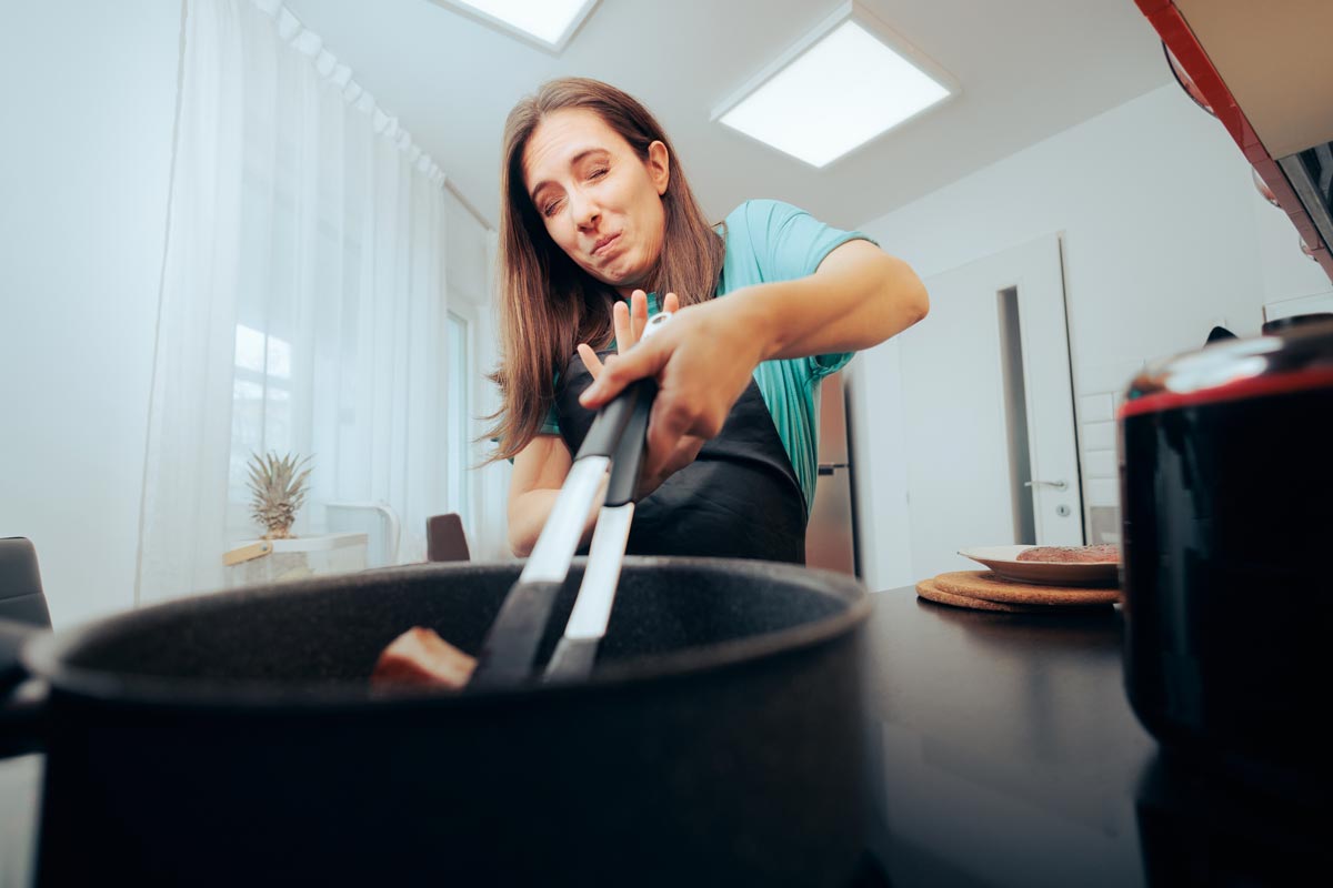 Woman Afraid of Hot Oil Accident Cooking with Her Eyes Closed