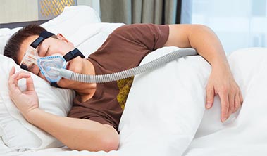 Sleeping man wearing cpap mask.